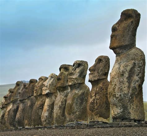 Download Majestic Row Of Moai Statues On Stone Platform Wallpaper