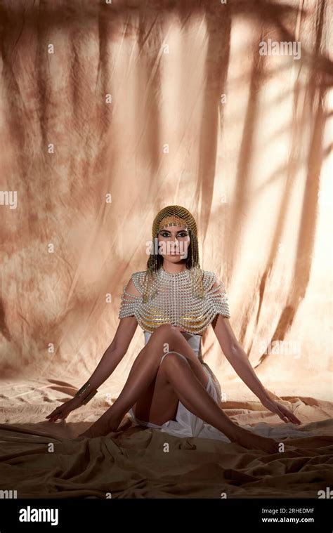 Stylish Brunette Woman In Egyptian Attire And Makeup Posing While