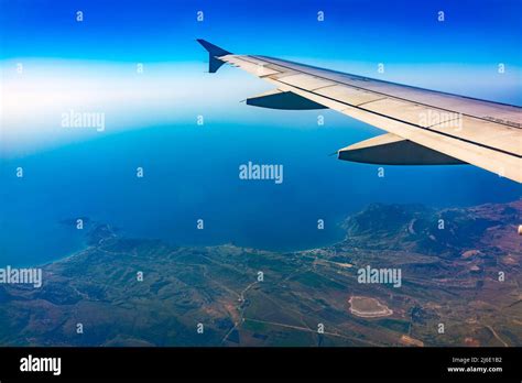 View From The Airplane Window At A Beautiful Blue Clear Sky Earth Sea