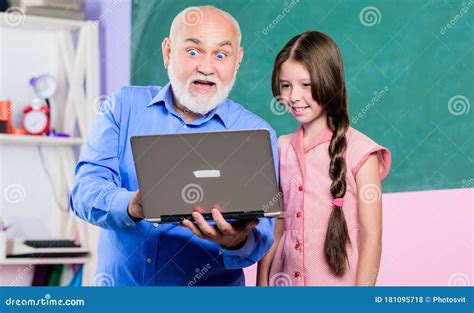 Mature Teacher Help Pupil Girl School Lesson Online Search Engine Small Girl With Man Tutor