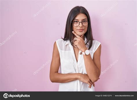 Brunette Young Woman Standing Pink Background Wearing Glasses Looking