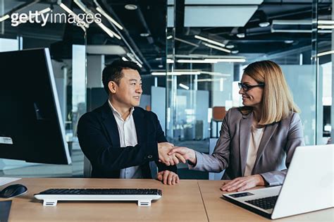 Two Colleagues Shaking Hands Man And Woman Business People Team