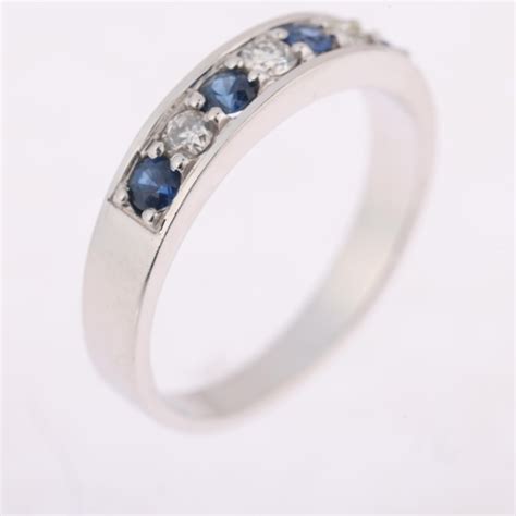 An Ct White Gold Seven Stone Sapphire And Diamond Half Eternity Ring