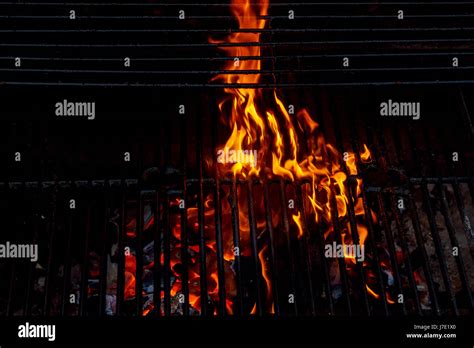 Hot Empty Charcoal BBQ Grill With Bright Flames On The Black Background Cookout Concept Stock