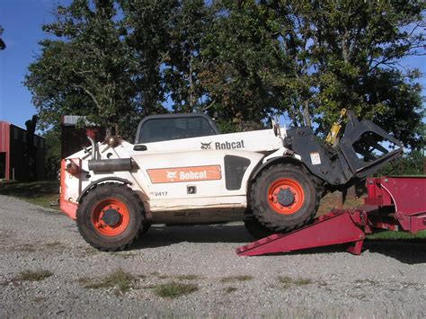 Driving tractor with the front end loader bucket elevated . | Page 3 ...