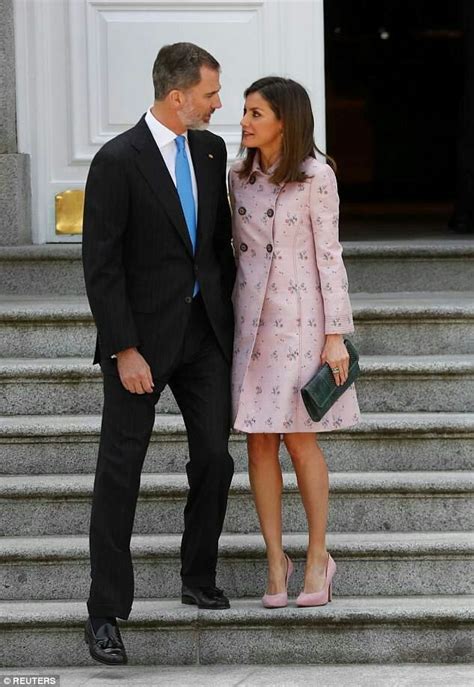 The President And First Lady Are Standing On Steps