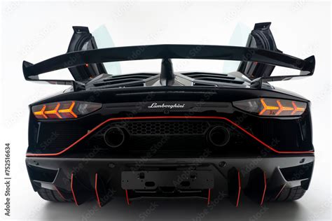 Rear end view of a matte black Lamborghini Aventador SVJ with scissor ...