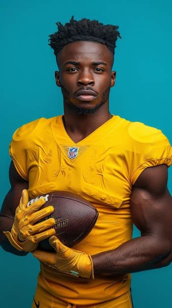 Premium Photo Man In Yellow Uniform Holding Football