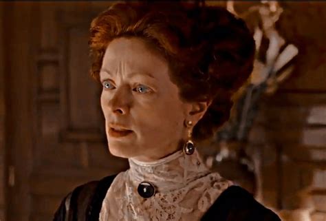 An Older Woman With Red Hair And Blue Eyes