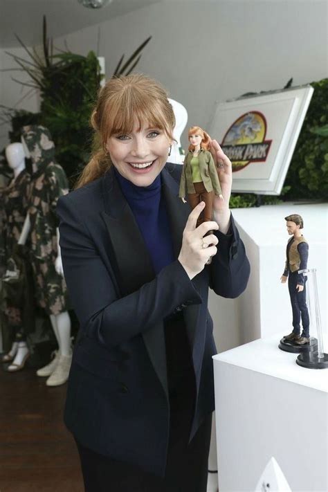 A Woman Holding A Toy In Her Hand And Smiling At The Camera With Other