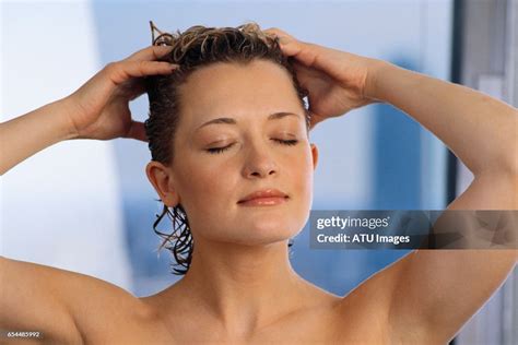 Woman Touching Her Wet Hair Photo Getty Images