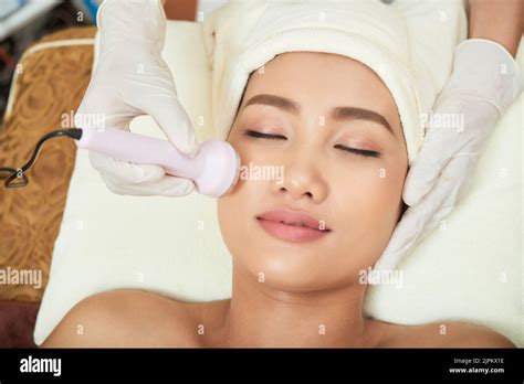 Close Up Shot Of Beautician Hands Making Ultrasound Facial Procedure