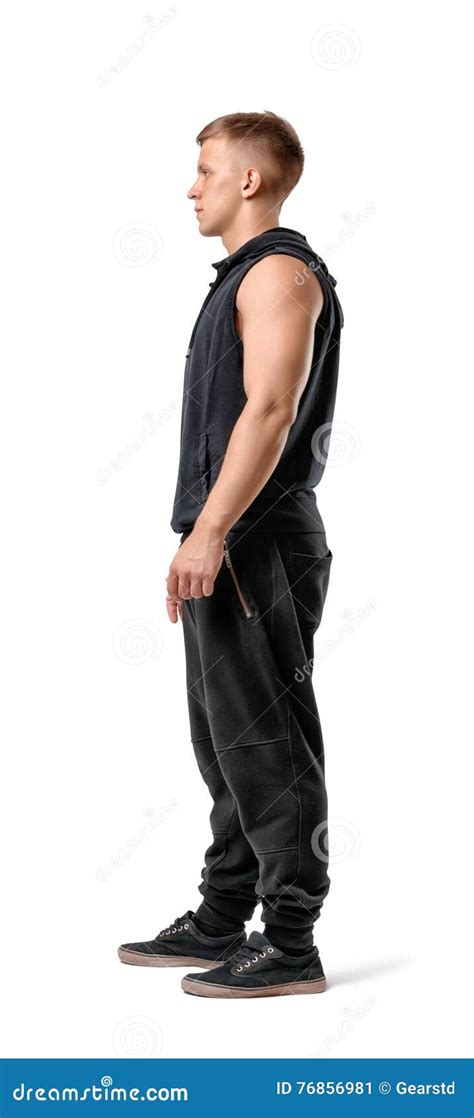 Side View Of Muscled Young Man Standing Isolated On White Background