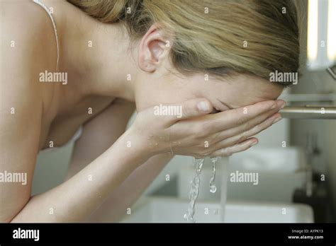 A Blonde Woman Washing Her Face Stock Photo Alamy