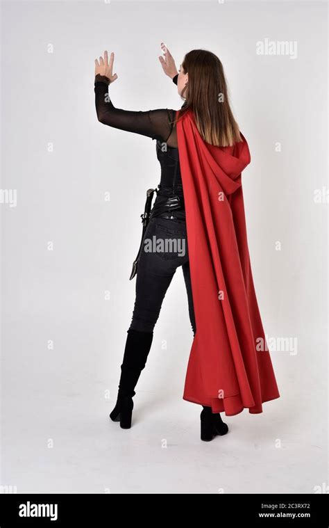 Portrait Of Brunette Girl Wearing Black Leather Catsuit Full Length Standing Pose Isolated