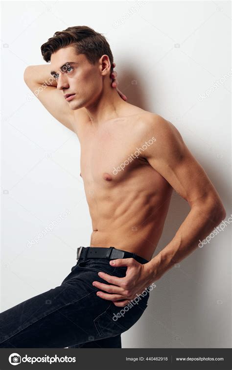 Guy With A Naked Torso Holds His Hand Behind His Head Side View Dark