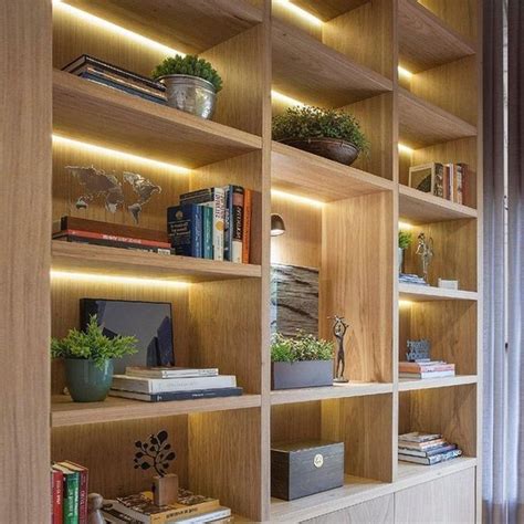 A Bookshelf Filled With Lots Of Books Next To A Window