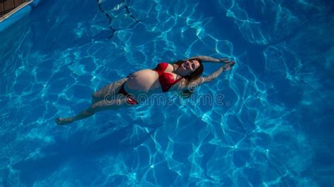 A Pregnant Woman In Nude Lingerie Stands In Profile Between Folding Doors Stock Image Image