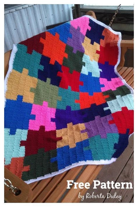 A Multicolored Blanket Sitting On Top Of A Wooden Bench Next To A Chain