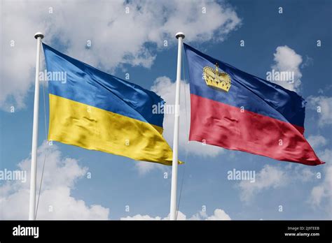 Ukraine And Liechtenstein Two Flags On Flagpoles And Blue Cloudy Sky