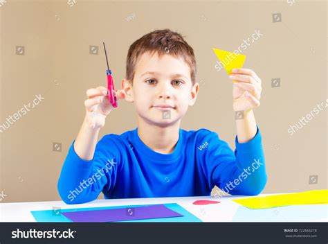 Boy Cutting Colored Paper Scissors Table Stock Photo