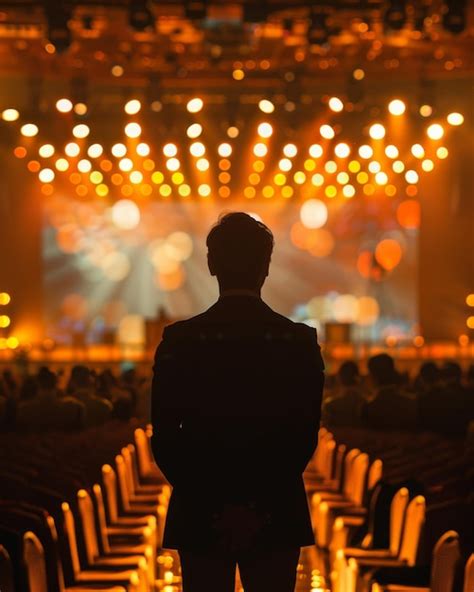 Premium Photo A Man Stands In A Dark Room With A Large Screen In