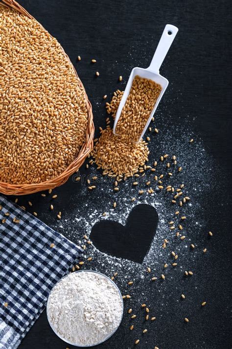 Composition With Wheat Grains Flour With Heart Shape On Black