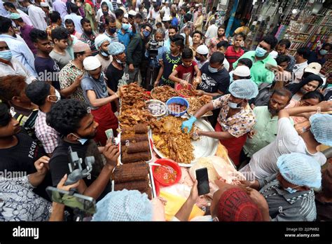 DHAKA,BANGLADESH- APRIL 3,2022:Street food vendors prepare and parcel