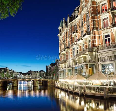 Night View of Amsterdam Canal and Hotel De L `Europe Building Editorial Image - Image of ...