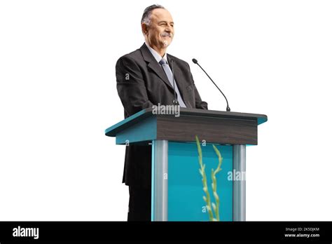 Mature Businessman Giving A Speech On A Podium And Smiling Isolated On