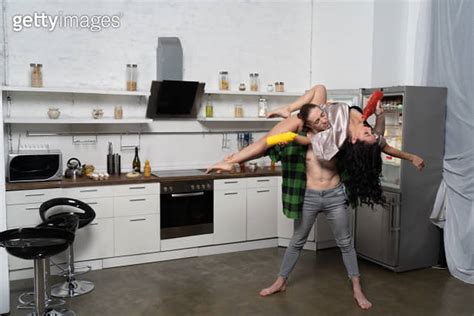 Nude Woman Flirting In The Kitchen With Man Concept Of Creative