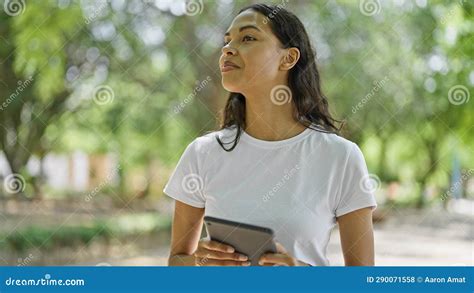 African American Woman Smiling Confident Using Touchpad At Park Stock