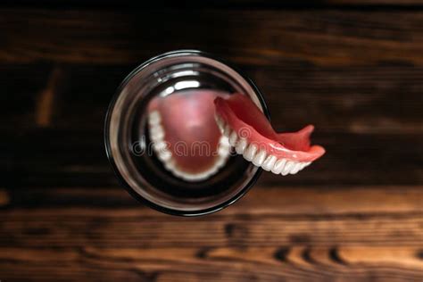 A Denture In A Glass Of Water Dental Prosthesis Care Full Removable