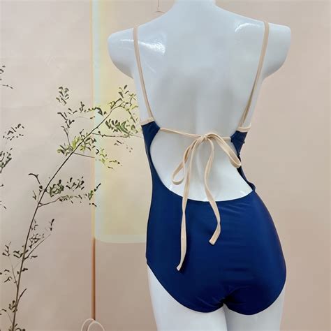 BIKINI LOẠI Bikini nữ liền mảnh đồ bơi nữ đi biển khoét lưng màu xanh đen viền dây BE cột