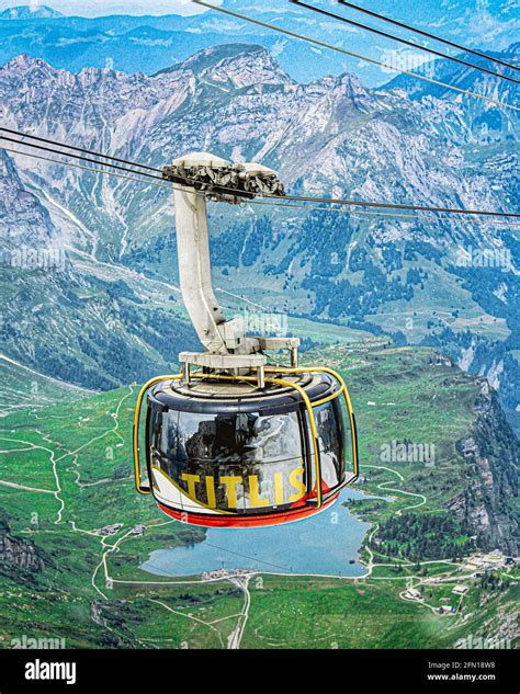 TITLIS Rotair cable car rotates its way up towards the snow-covered ...