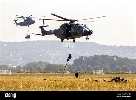 German Army Soldiers Fast Roping From A Nh90 Helicopter And A Sikorsky