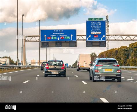 Cars and route information on overhead gantry, motorway A2 at exit to ...