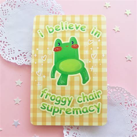 a yellow and white doily with a sticker on it that says i believe in froggy chair supremency