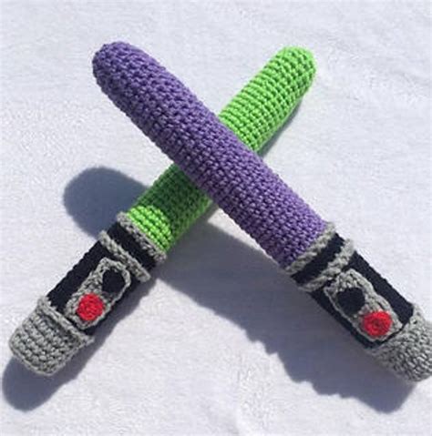 Two Crocheted Objects Are Laying On Top Of Each Other One Is Purple