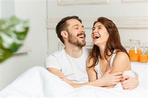 Free Photo Young Adult Heterosexual Couple Lying On Bed In Bedroom