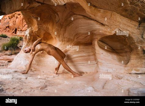 Naked Woman On Rock Aztec Sandstone State Park Mohave Desert Overton Nevada USA Stock