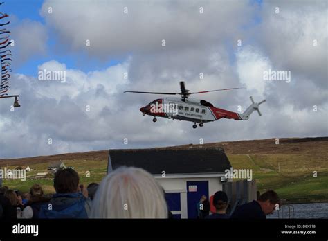 A Coastguard Helicopter Flies Over A Watching Crowd Stock Photo Alamy