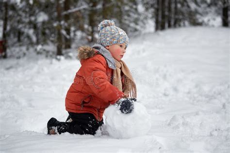 Divertimento Do Inverno O Menino Esculpe O Boneco De Neve Imagem De