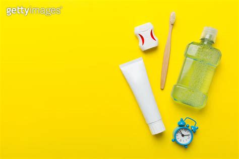 Mouthwash And Other Oral Hygiene Products On Colored Table Top View