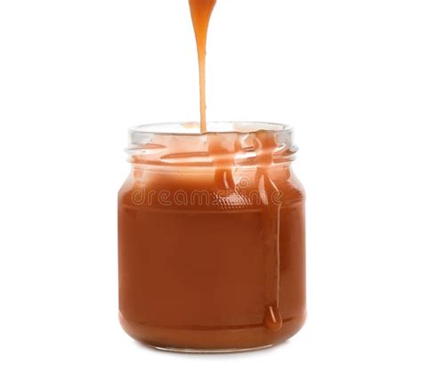 Tasty Caramel Sauce Pouring Into Jar Isolated Stock Photo Image Of