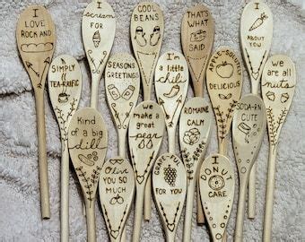 Many Wooden Spoons With Writing On Them