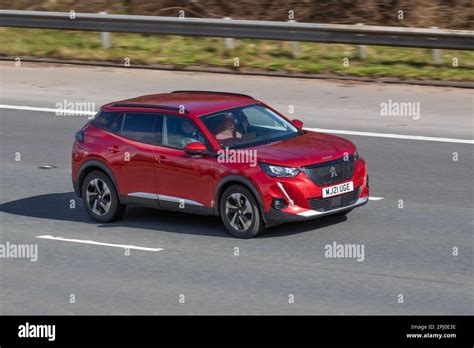 2021 Red Peugeot 208 Allure Premium Ptech Ss Gt Travelling On The M61