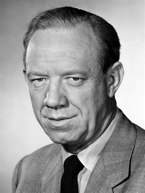 an old black and white photo of a man in a suit with his eyes wide open