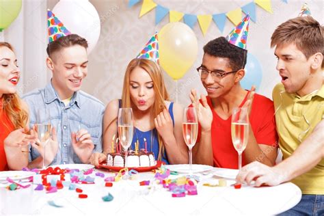 Young people celebrating a birthday sitting at the table — Stock Photo ...