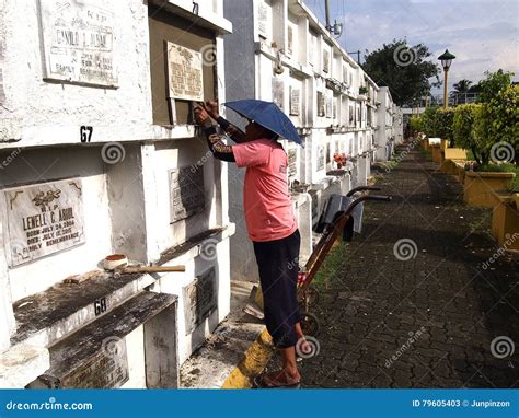 A Worker Sets A Tombstone On A Grave At A Cemetery Editorial Stock